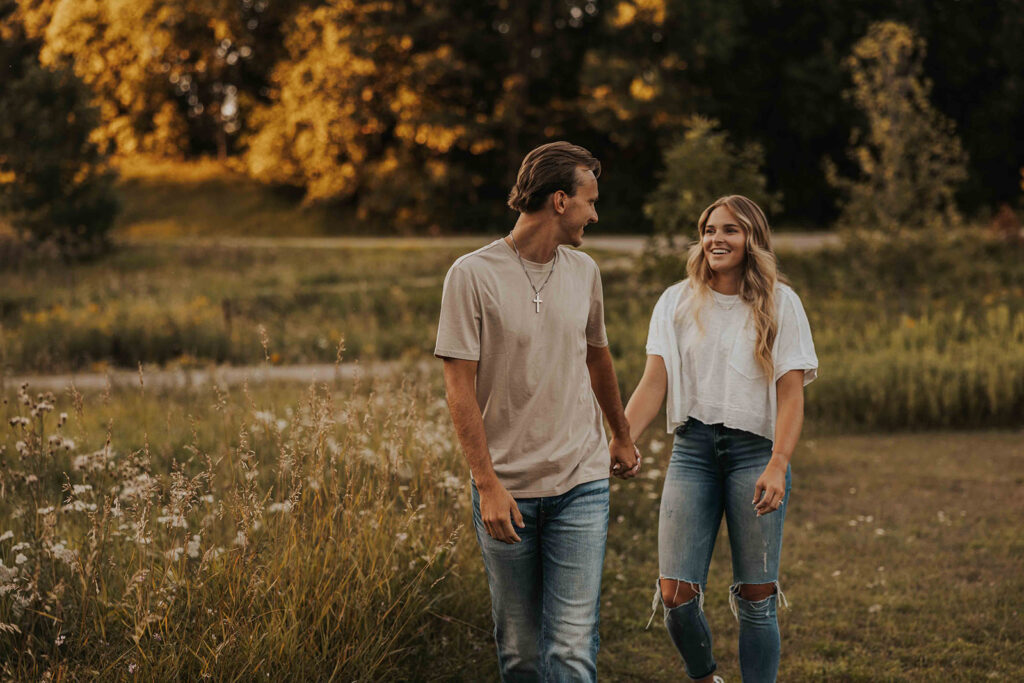 playful and romantic field engagement photos in Sibley State Park, MN