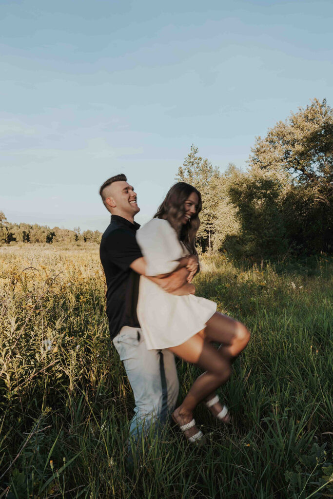 candid and romantic future bride and groom celebrating their love at their engagement photo location