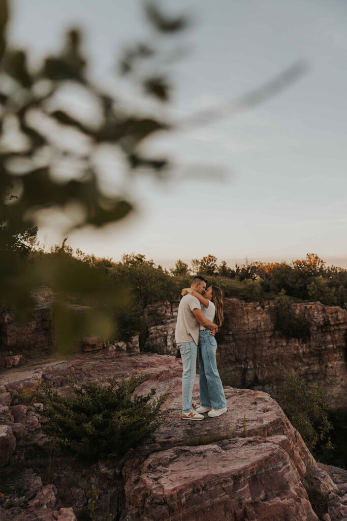 casual and adventurous couple at their engagement photo location in Blue Mounds State Park