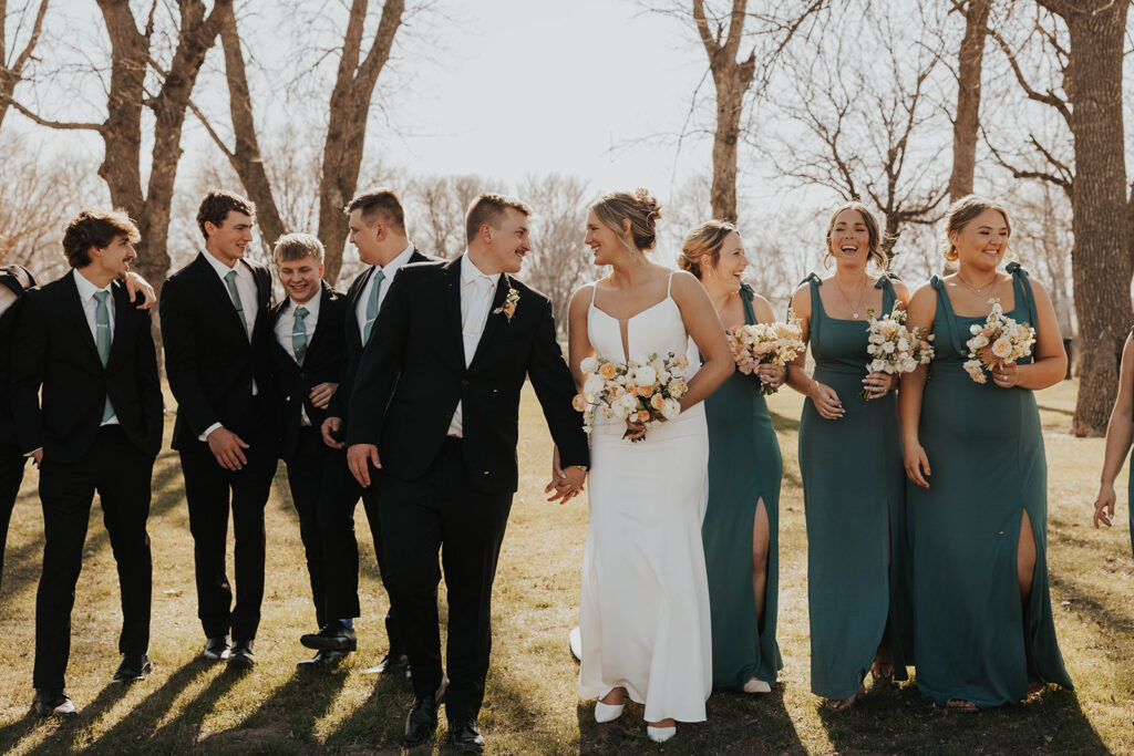 joyful bride and groom surrounded by their wedding party