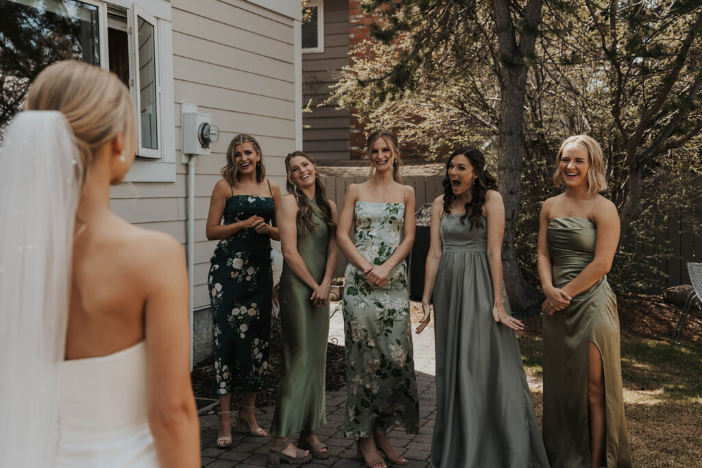 emotional bride and bridesmaids first look