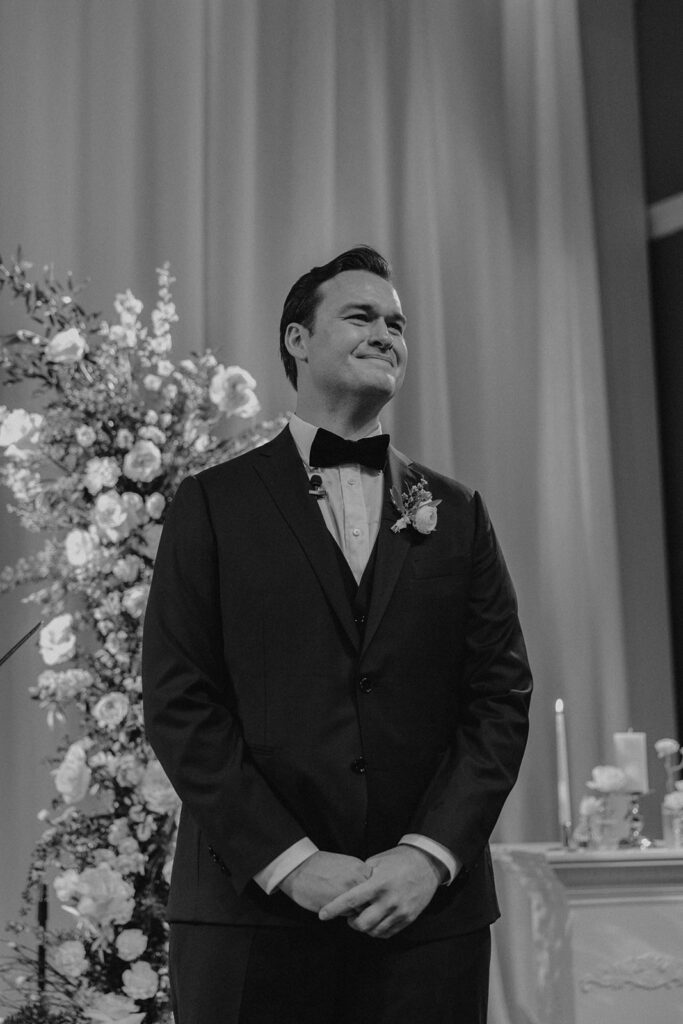 groom waiting at the aisle during wedding ceremony at the McKenzie Towne Church