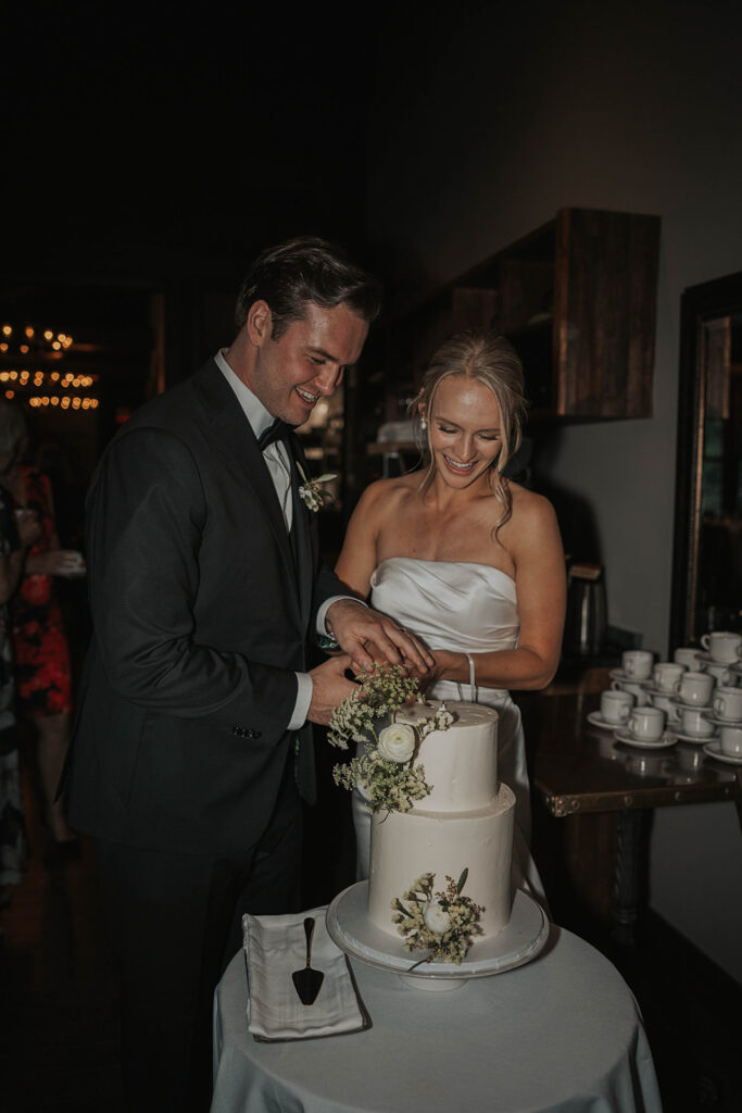 bride and groom cutting cake