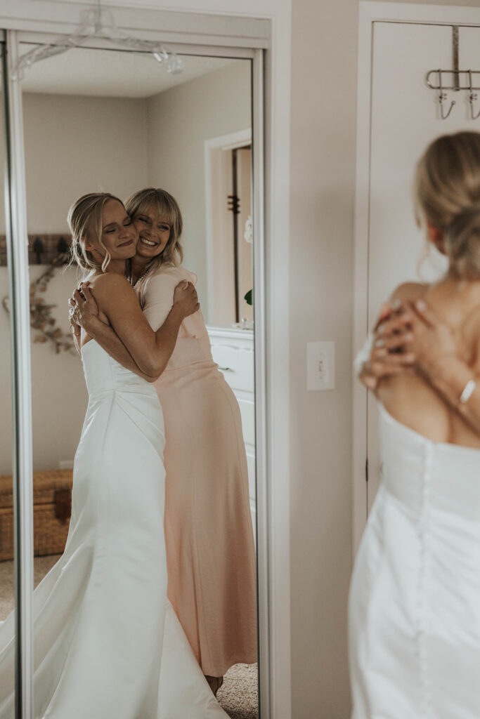 bride and mom hugging during the getting ready photos at bride's parent's house