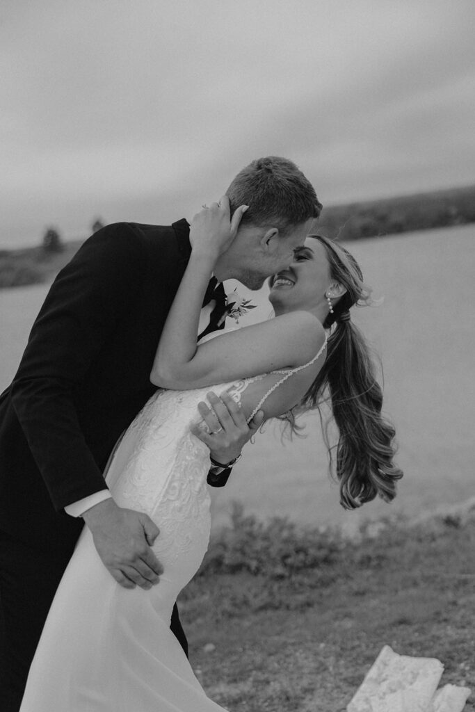 romantic bride and groom photo with water in the backdrop