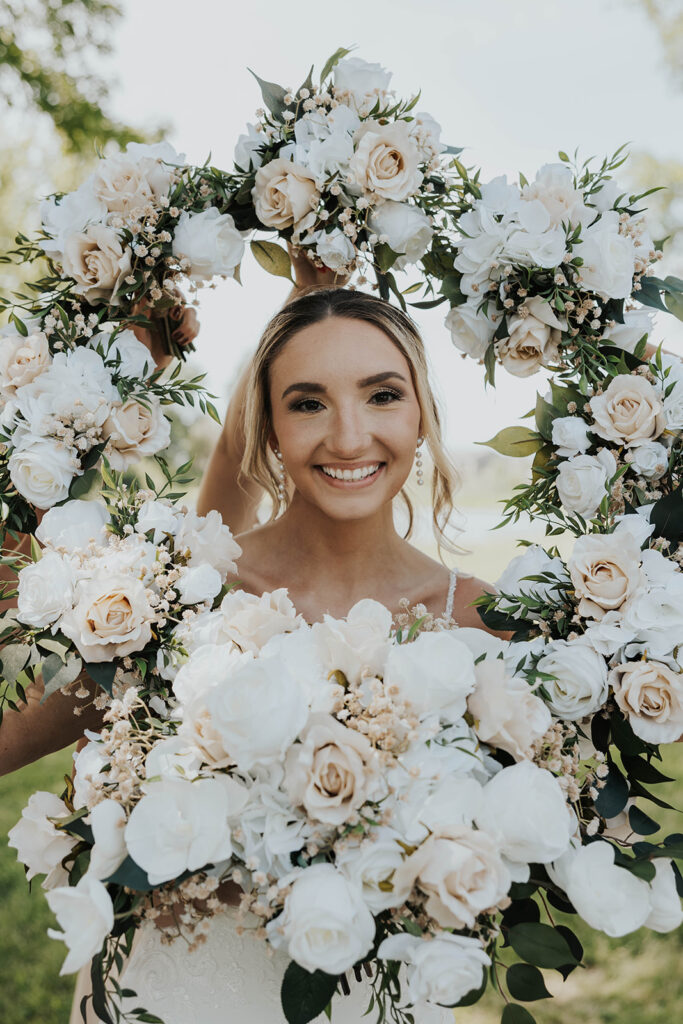 bride surrounded by a frame of bridesmaid bouquets