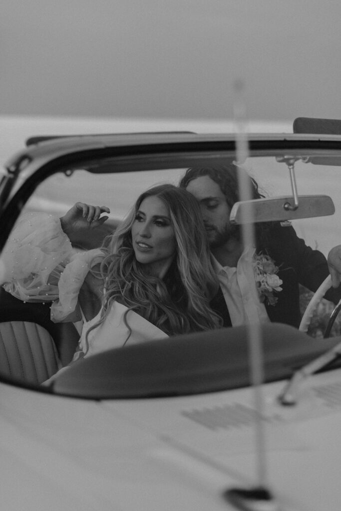 bride and groom in a vintage car