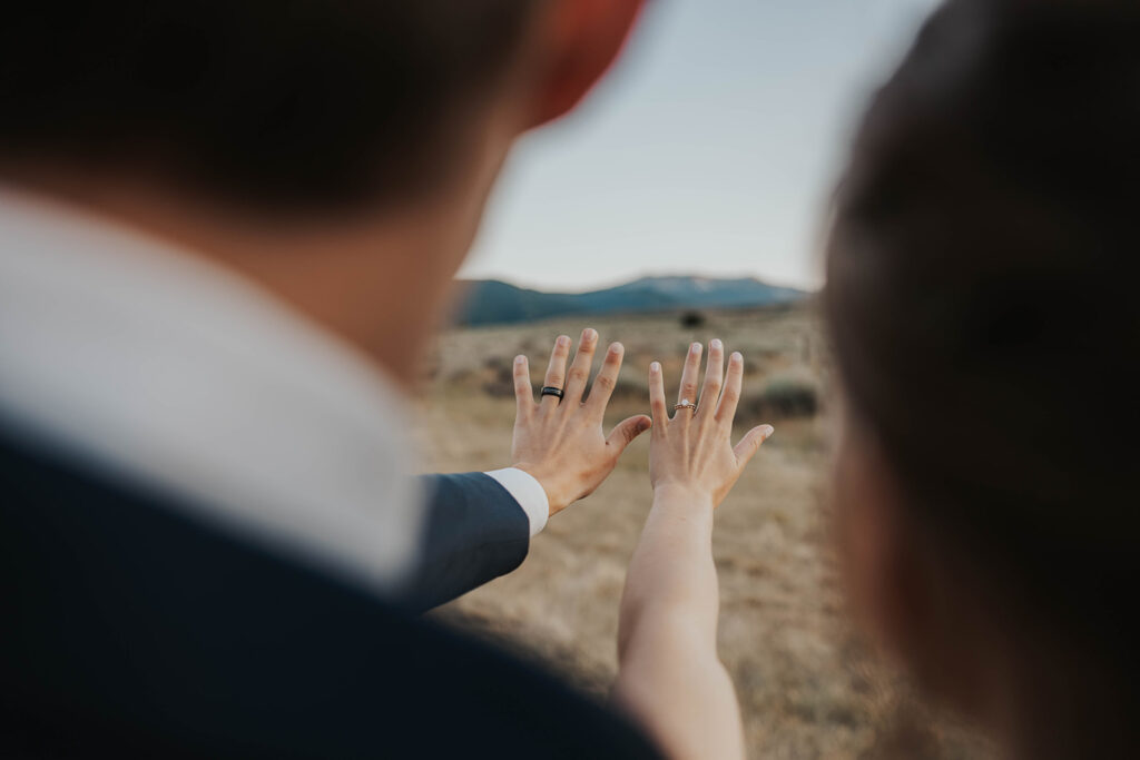 bride and groom looking at their wedding rings