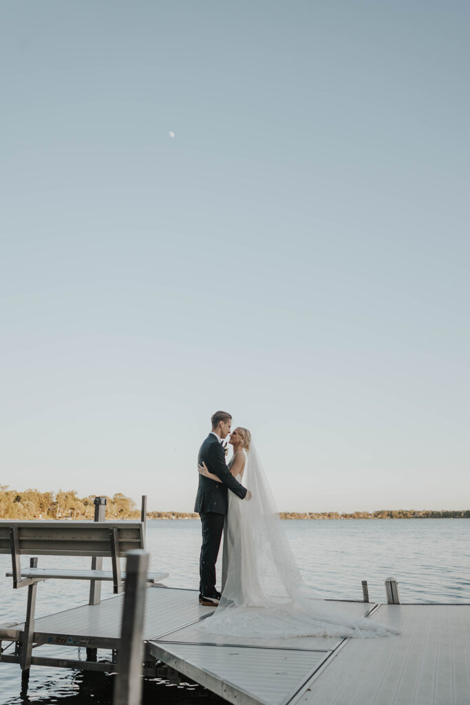 romantic bride and groom at a lake shore during their destination elopement wedding