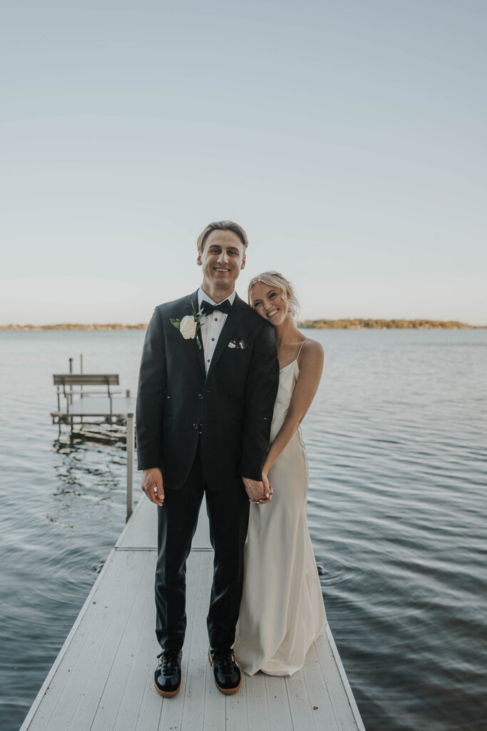 romantic bride and groom at a lake shore during their destination elopement wedding