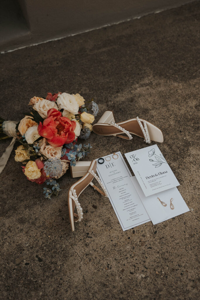 classy timeless wedding detail flatlay of shoes, bouquet, loose florals