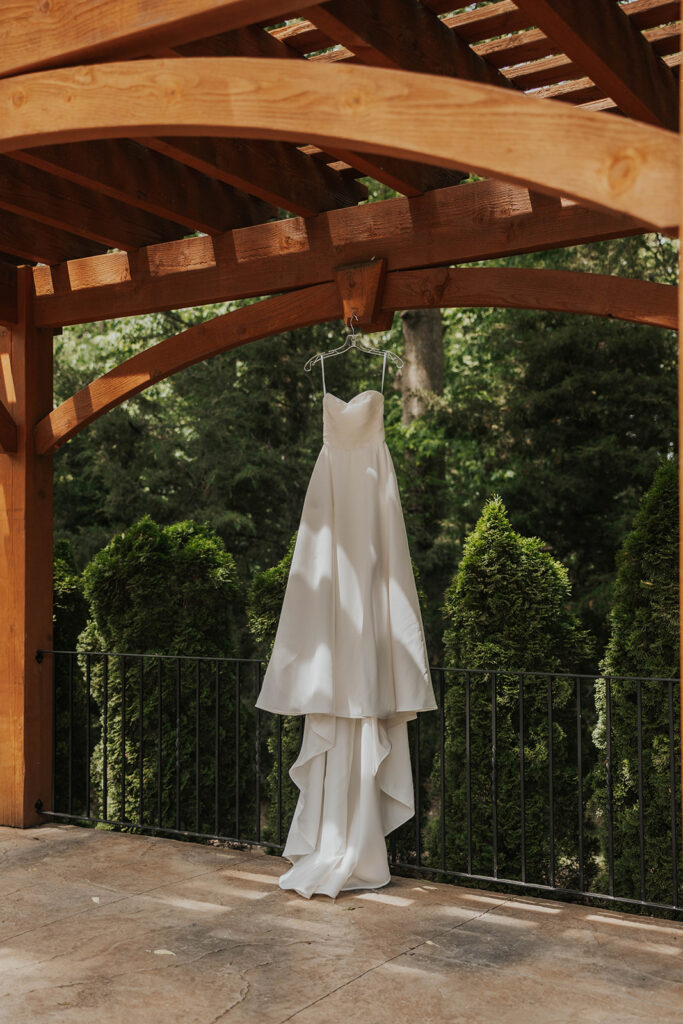 wedding dress hanging in a natural setting for a destination wedding