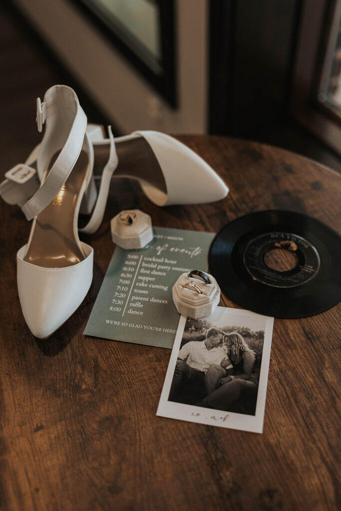 classy timeless wedding detail flatlay of shoes, bouquet, loose florals