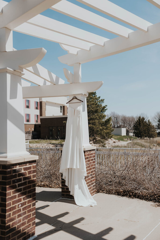 wedding dress hanging in a natural setting for a destination wedding