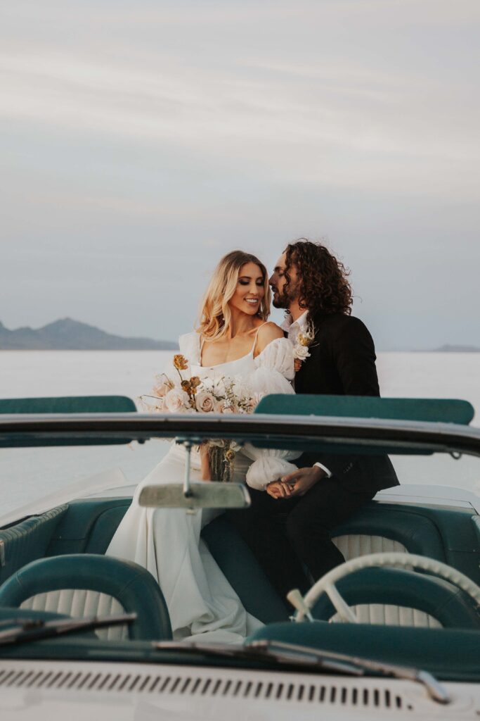 Couple sitting in a car at their elopement in Salt Flats, Utah