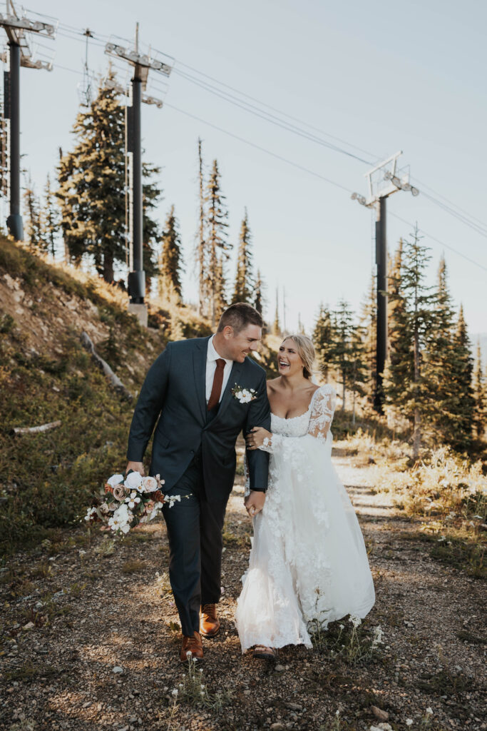 A couple having a good time in front of a ski lift at Whitefish Mountain Resort