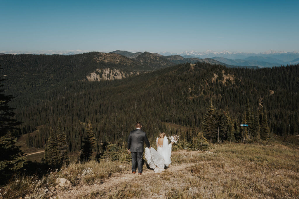 A couple walking down a mountain at Whitefish Mountain Resort