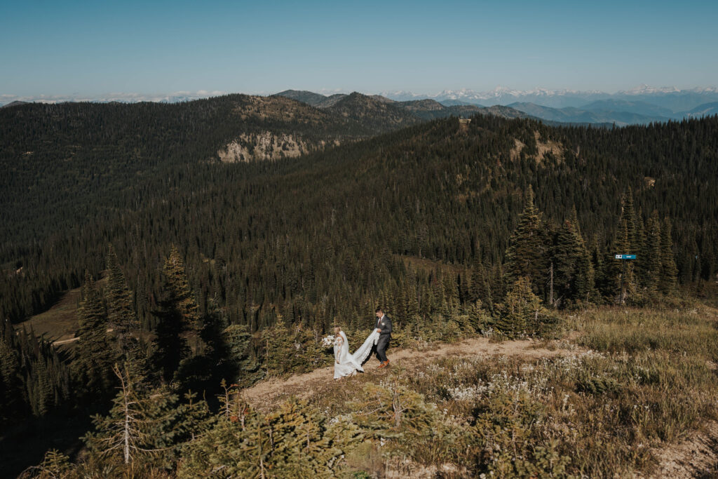 A couple walking down a mountain at Whitefish Mountain Resort