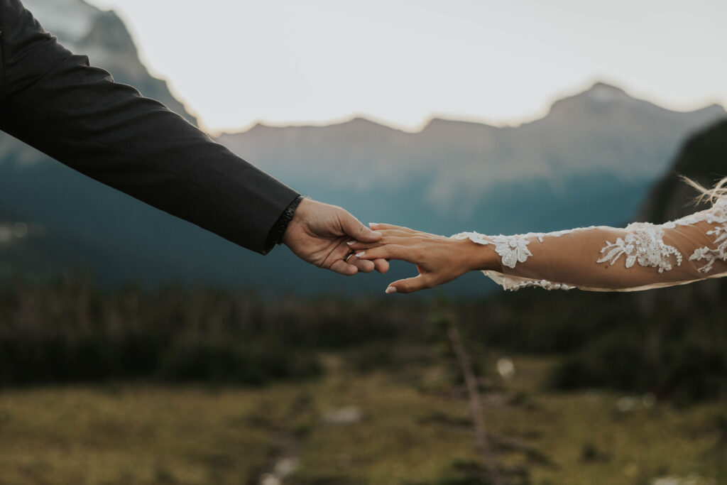 Couple holding hands in Glacier National Park