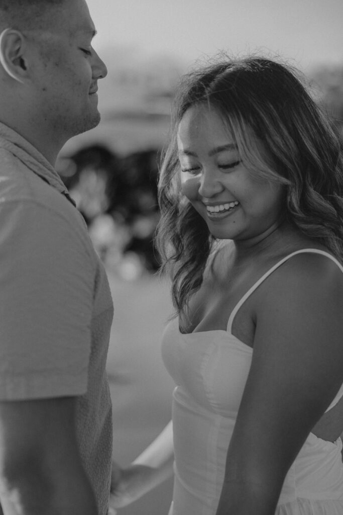 Black and white image of a couple on Po'olenalena Beach, Maui.