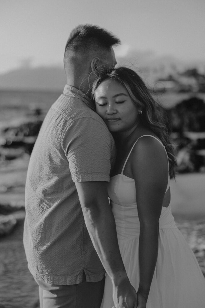 Black and white image of a couple on a Maui beach.