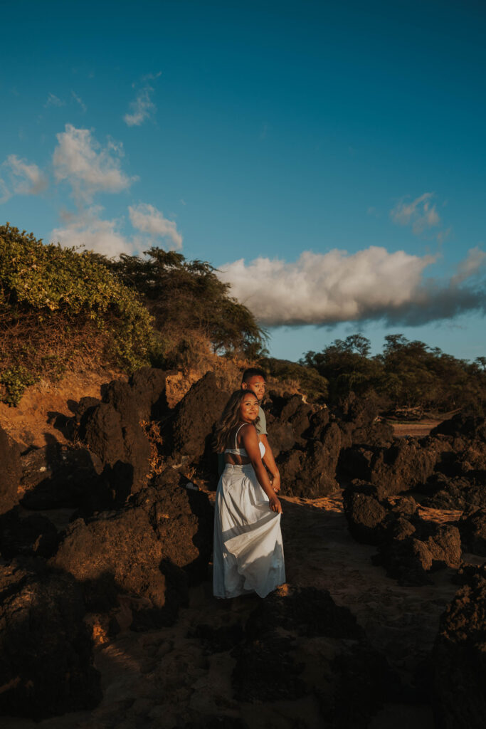 Couple walking near rocks on Po'olenalena Beach, Maui.