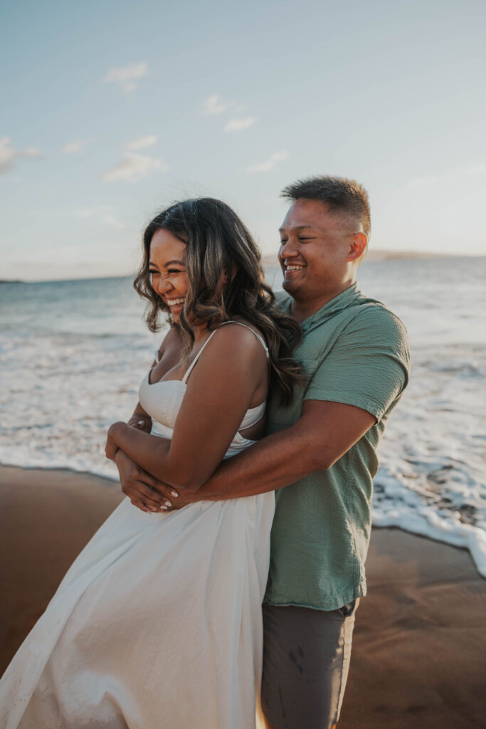 Playful couples photos in front of a beautiful Hawaii beach.