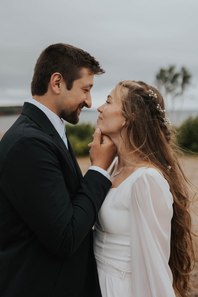 Couple looking at each other in Prince Edward Island, Canada during their destination wedding