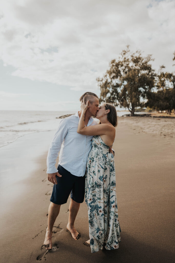 Couple kissing on a beach in Hawaii