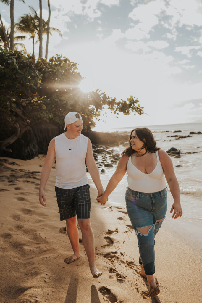 Couple walking together on a beach in Hawaii