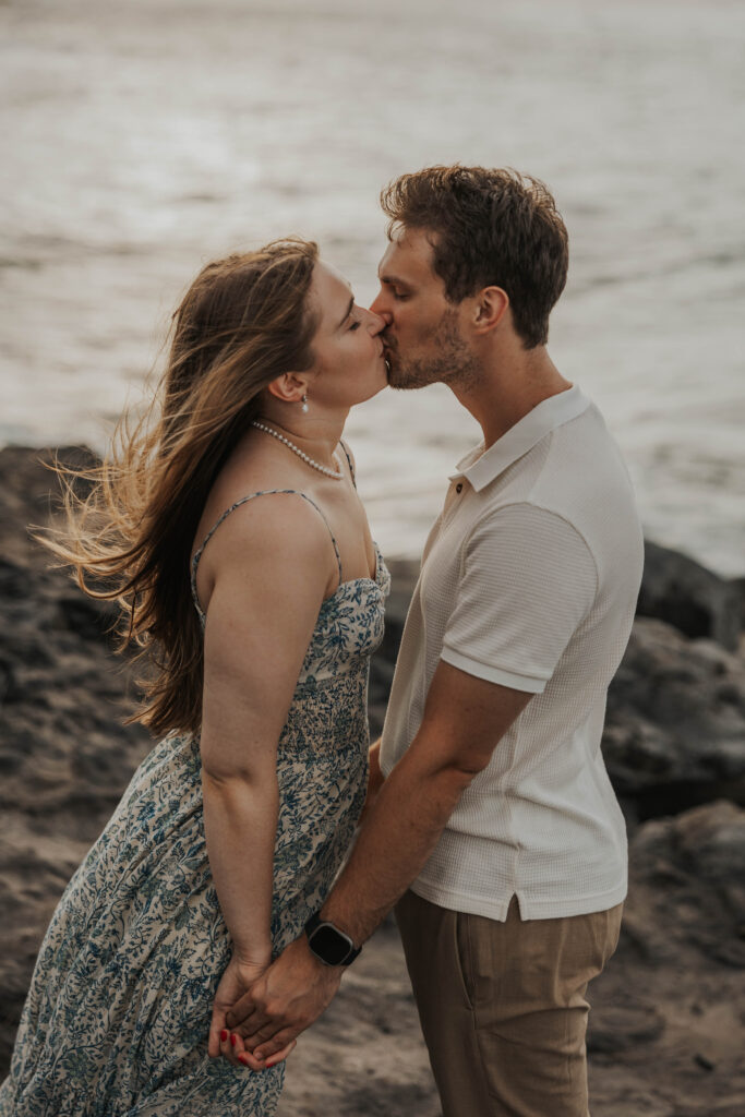 Couple kissing on a beach during their engagement photoshoot in Maui, Hawaii 