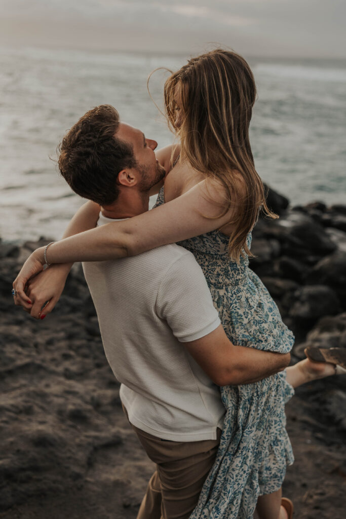 Couple being playful during an engagement session in Maui