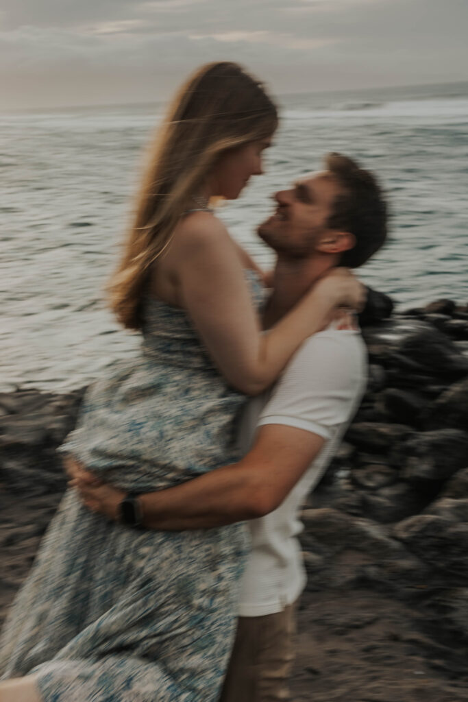 Couple being playful during an engagement session in Maui