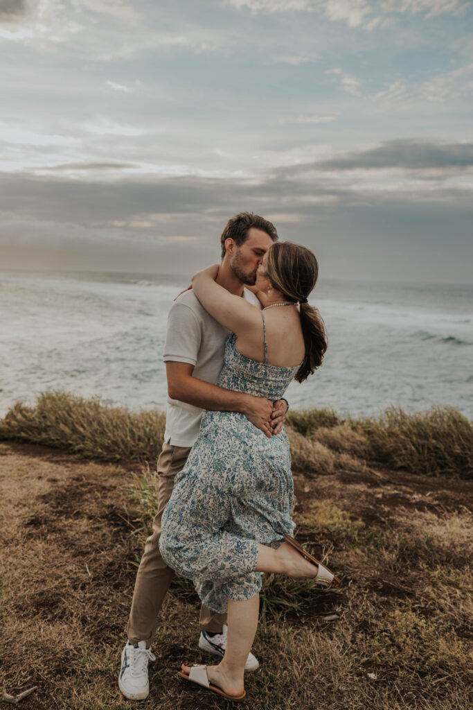 Couple kissing on a beach during their engagement photoshoot in Maui, Hawaii 