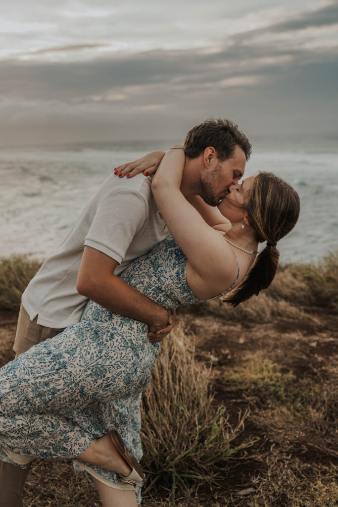 Couple kissing on a beach during their engagement photoshoot in Maui, Hawaii 