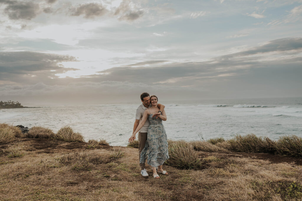 Couple having fun during their beach engagement photoshoot in Maui