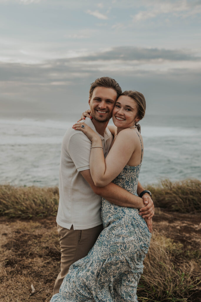 Couple smiling on a beach in Hawaii