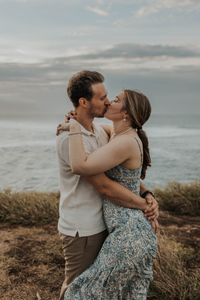 Couple kissing on a beach during their engagement photoshoot in Maui, Hawaii 