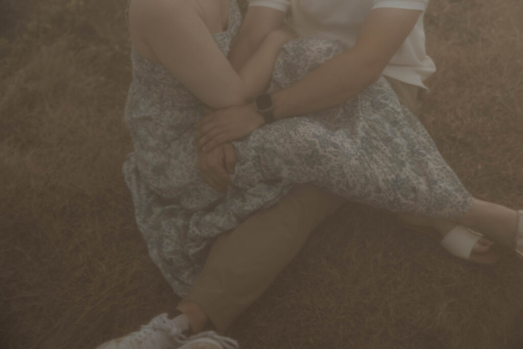 Details of a couple sitting during their engagement session on a Maui