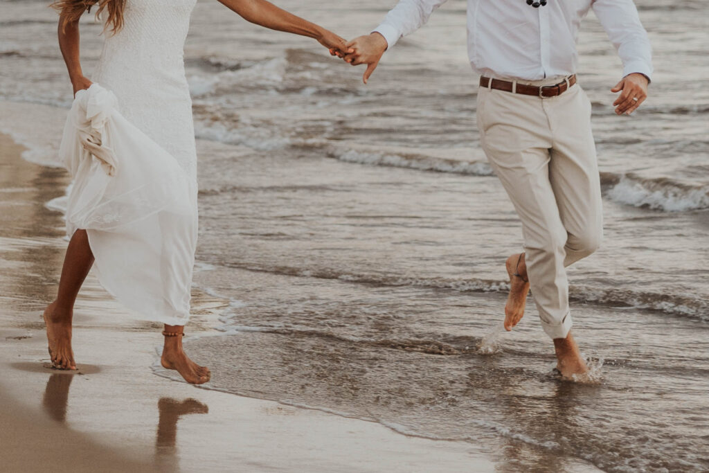 Couple running on a Maui beach in Hawaii