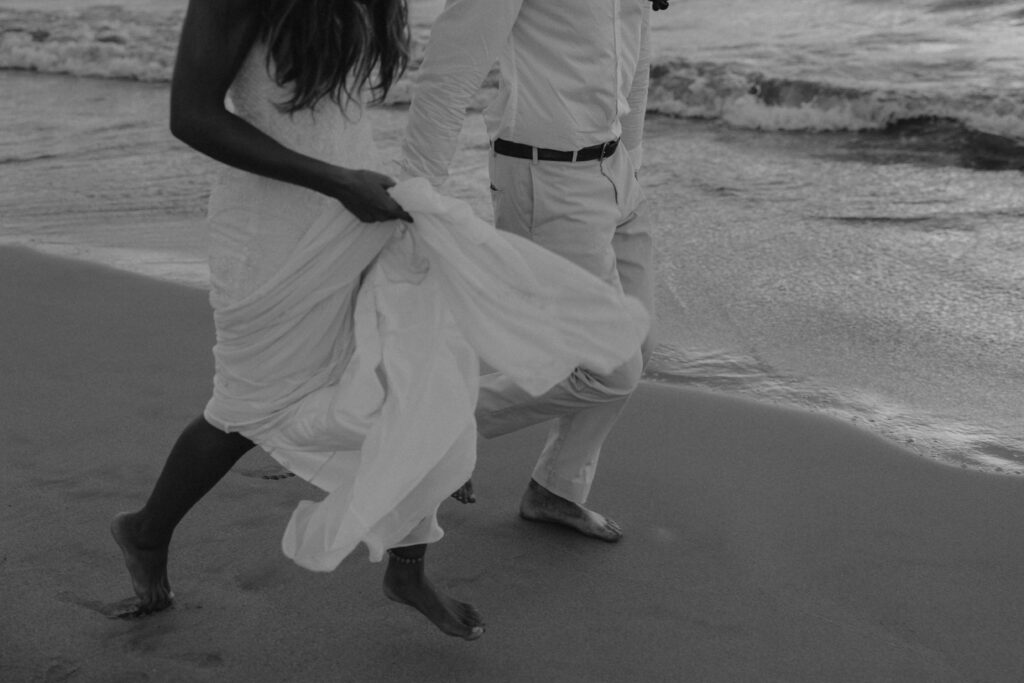 Couple running on a Maui beach in Hawaii