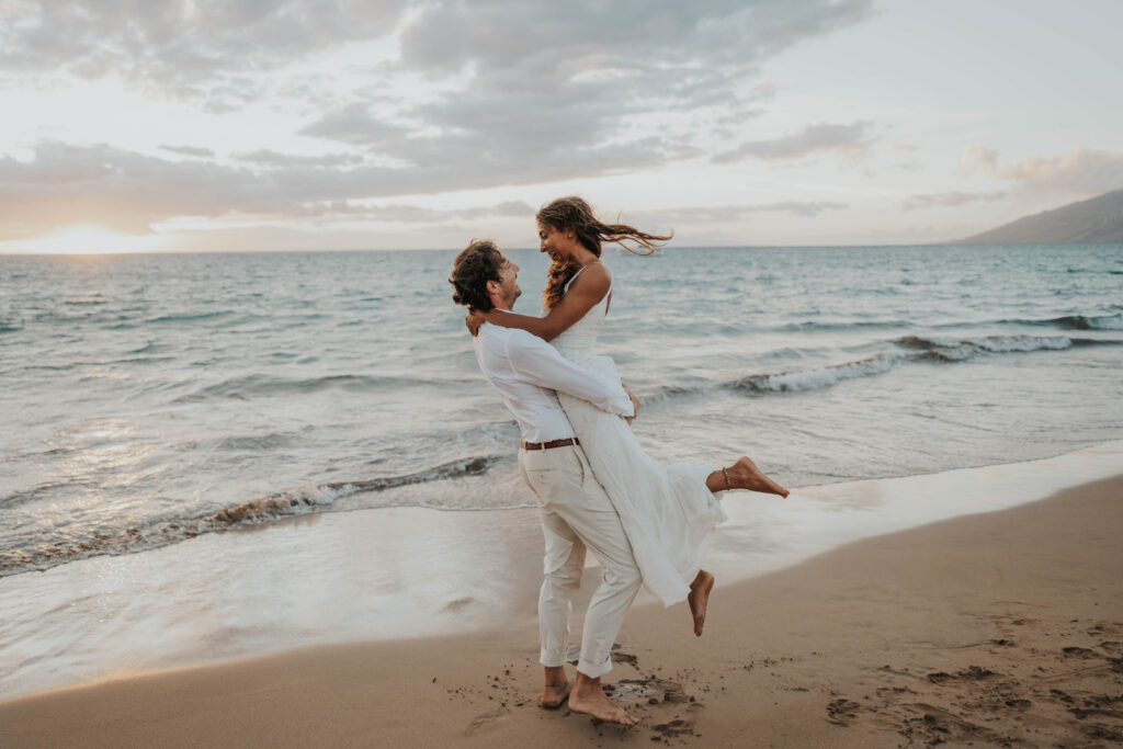 Couple eloping on a Maui beach during sunset