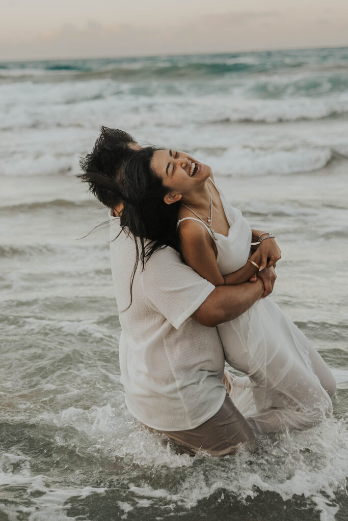 playful engagement pictures on the beach