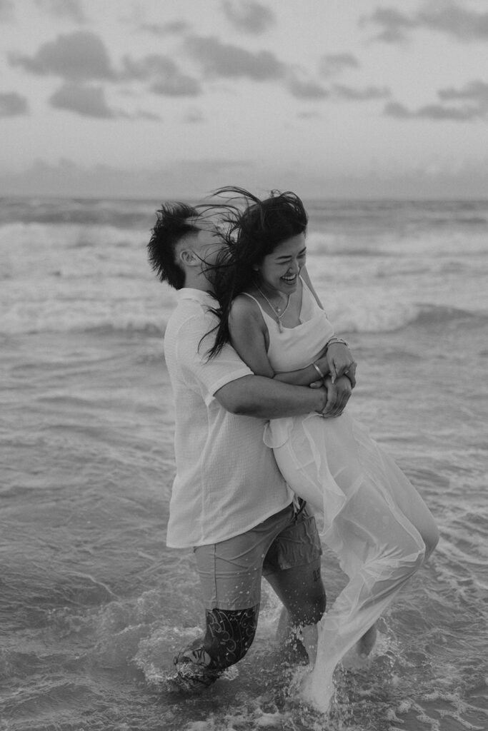 playful engagement pictures on the beach