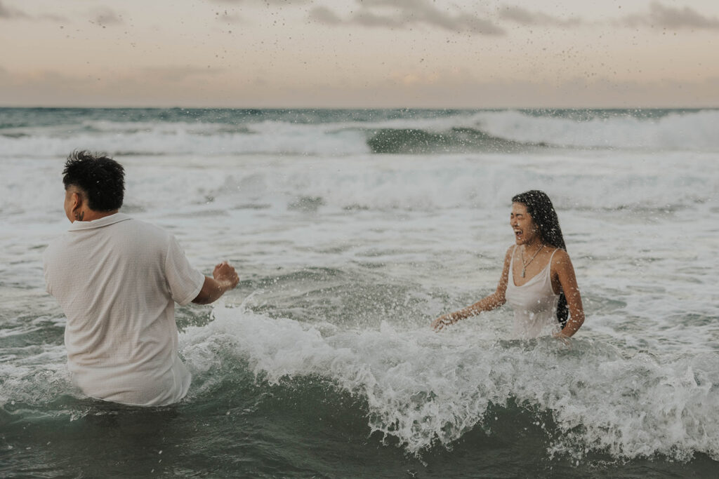 playful engagement pictures on the beach