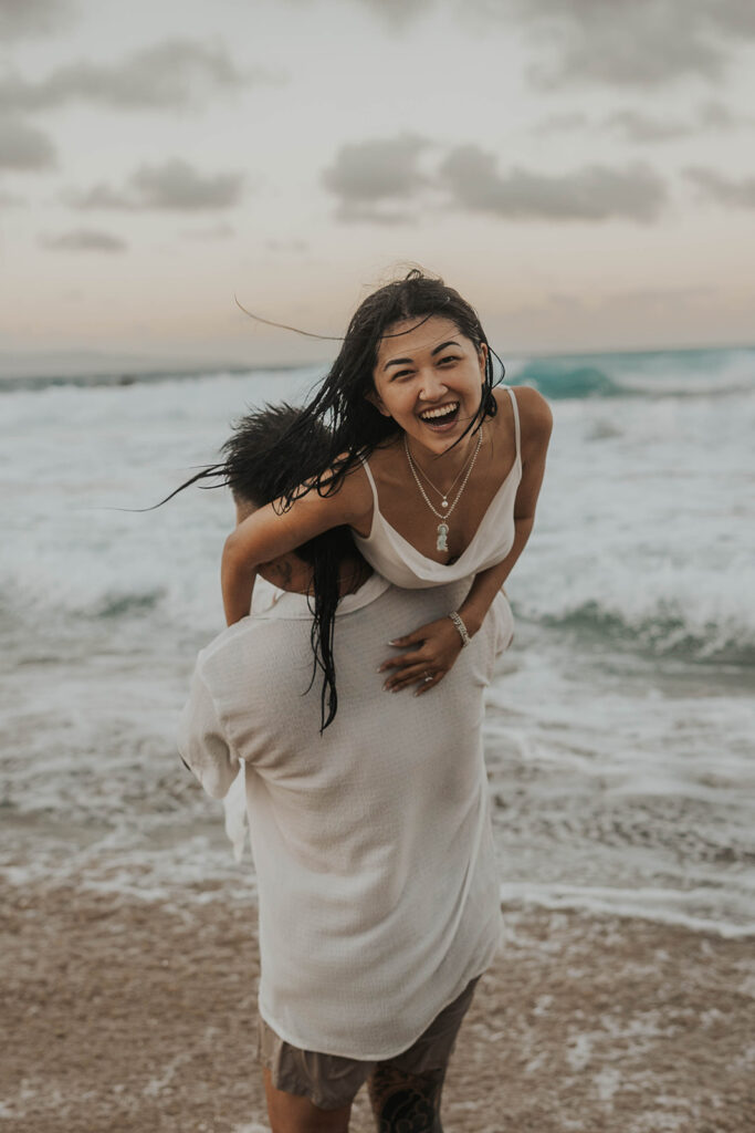 playful engagement pictures on the beach