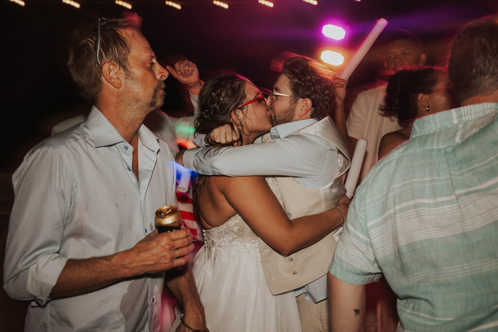 flash wedding reception photos bride and groom kissing