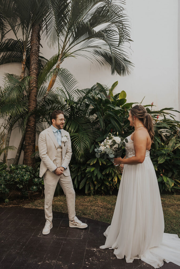 bride and groom sharing private vows in front of palm trees