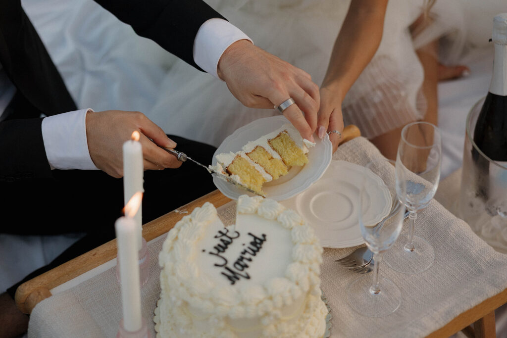 bride and groom sharing a picnic on the beach