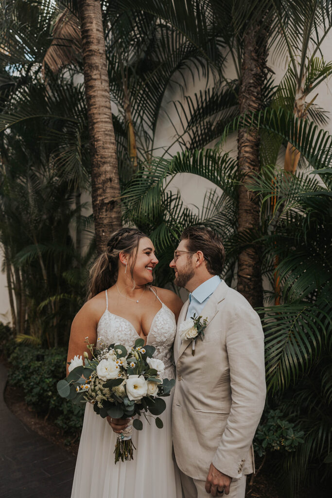 bride and groom sharing private vows in front of palm trees